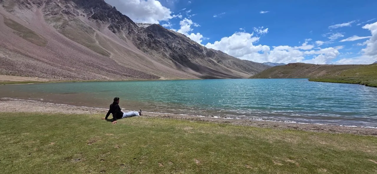 Kulwant sitting on the shore of the turquoise Chandratal Lake
