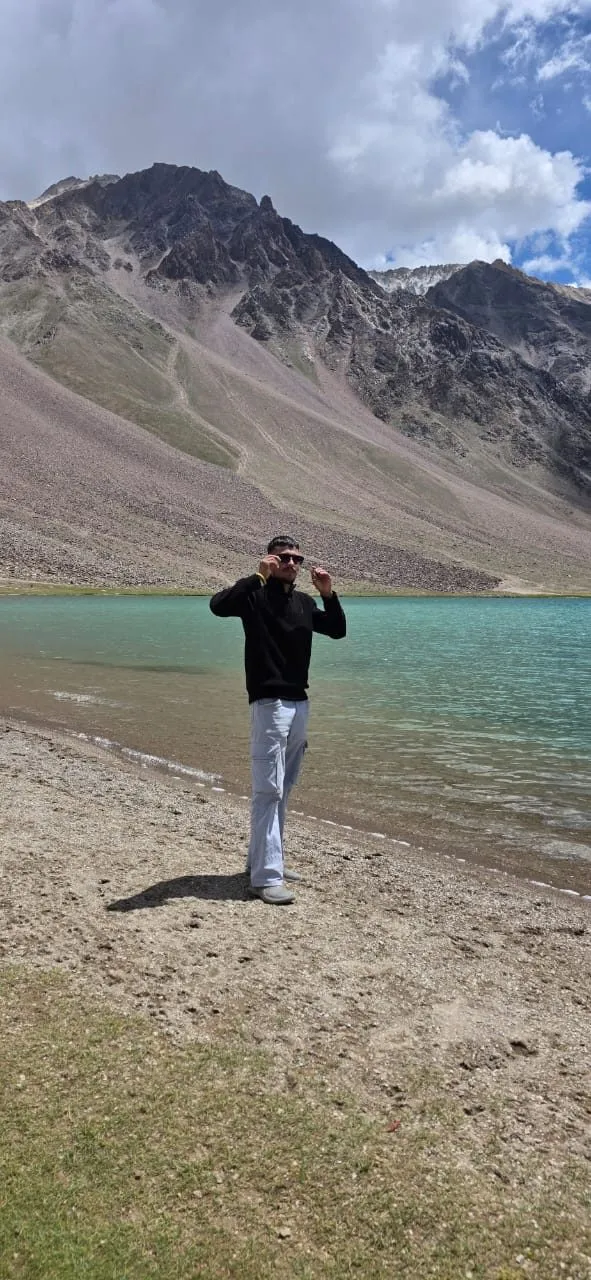 Kulwant standing beside the turquoise waters of Chandratal Lake