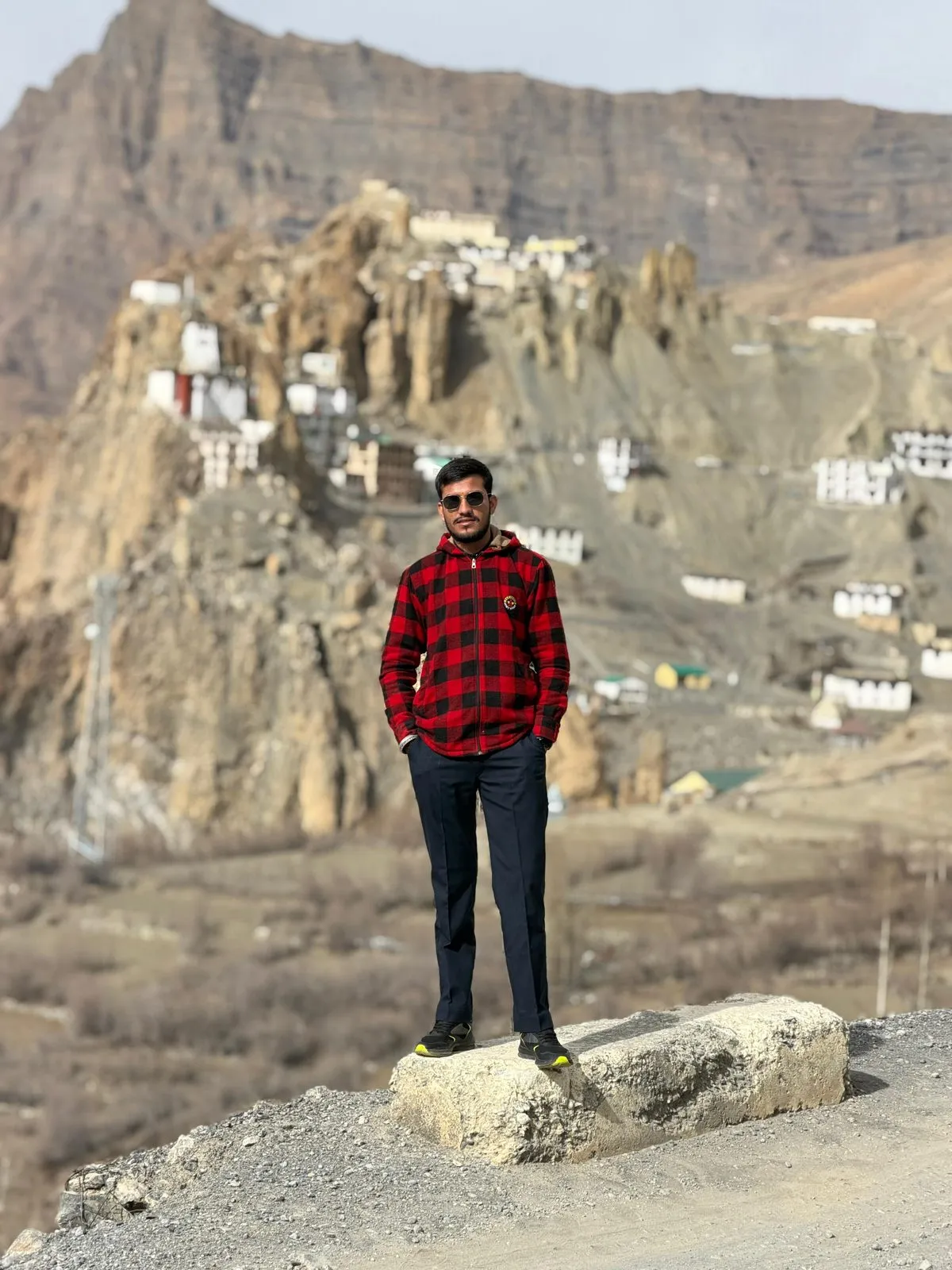 Kulwant standing before Dhankar Monastery perched on its cliffside